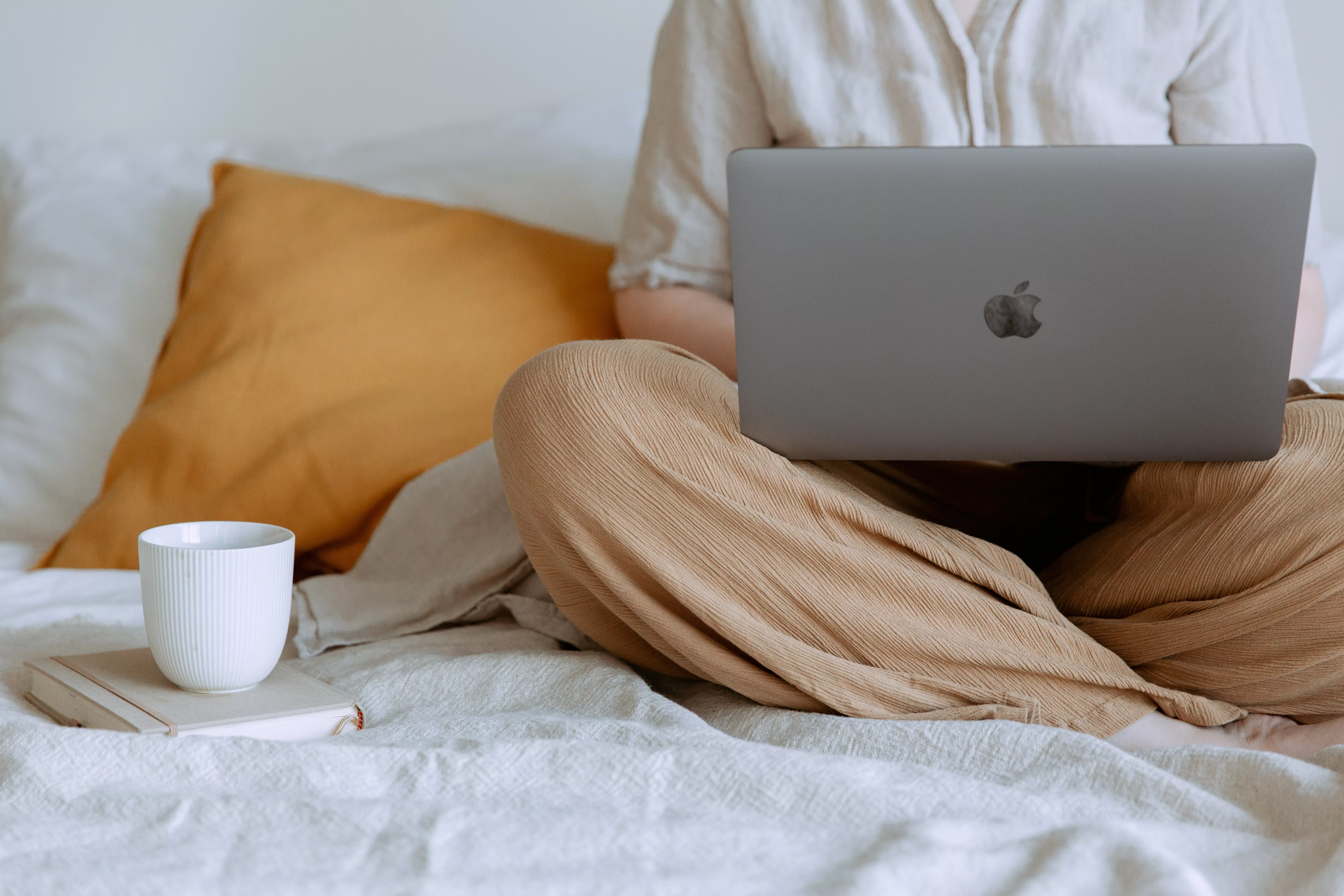 Person sitting with computer on lap